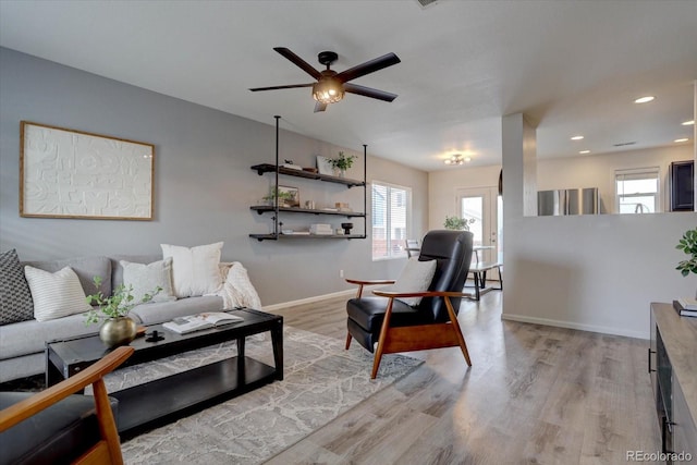 living area featuring recessed lighting, light wood-style floors, baseboards, and ceiling fan