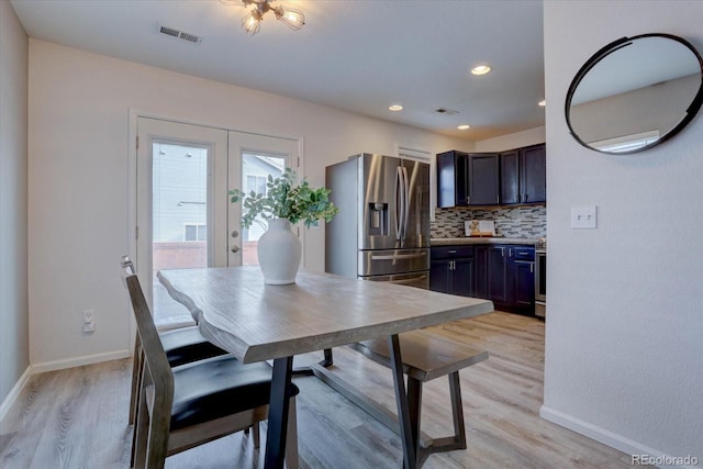 dining room featuring visible vents, baseboards, recessed lighting, light wood-style flooring, and french doors