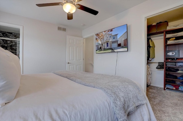 carpeted bedroom featuring visible vents and ceiling fan