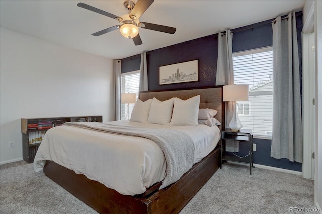 carpeted bedroom with a ceiling fan and baseboards