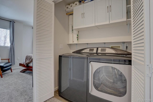 washroom with washer and dryer, baseboards, cabinet space, and light colored carpet