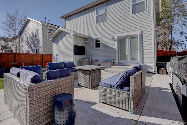 rear view of property featuring outdoor lounge area, a patio, french doors, and fence