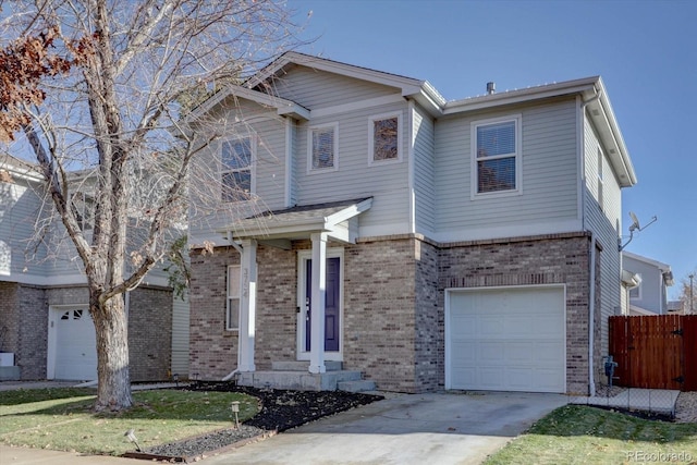 traditional-style home with brick siding, concrete driveway, a garage, and fence