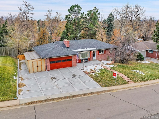 ranch-style house featuring a front yard and a garage