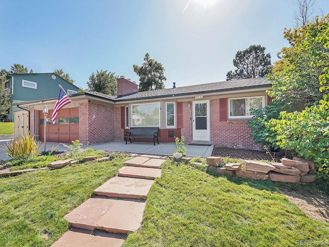 ranch-style house with a garage and a front lawn