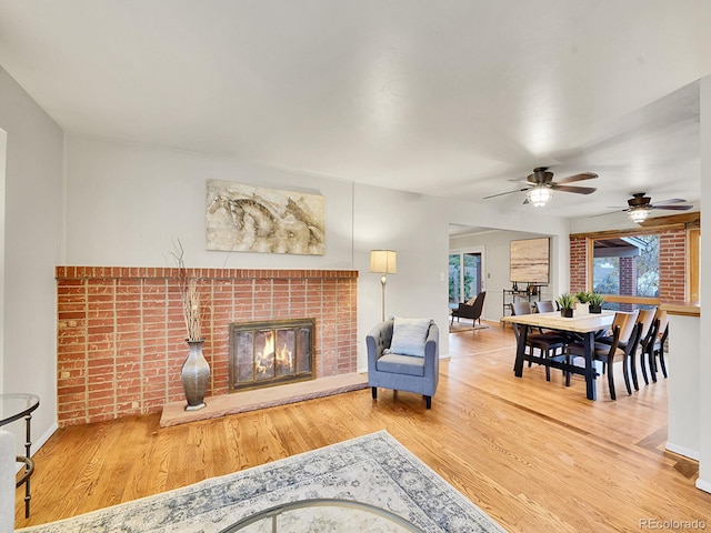 living room featuring hardwood / wood-style floors and ceiling fan