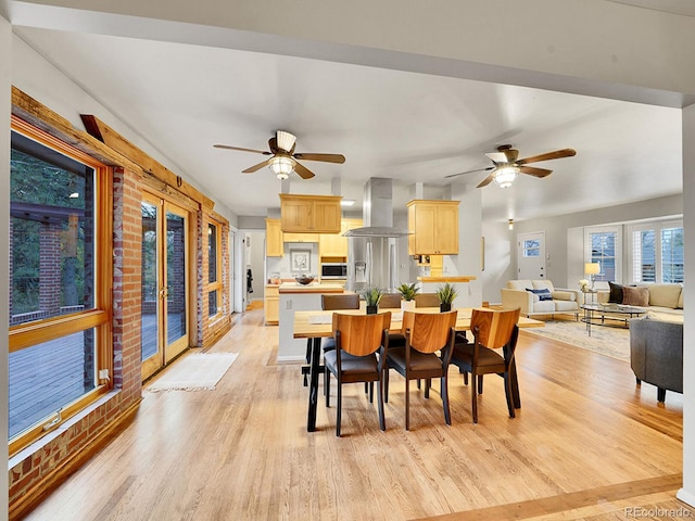 dining space with ceiling fan, french doors, and light hardwood / wood-style floors