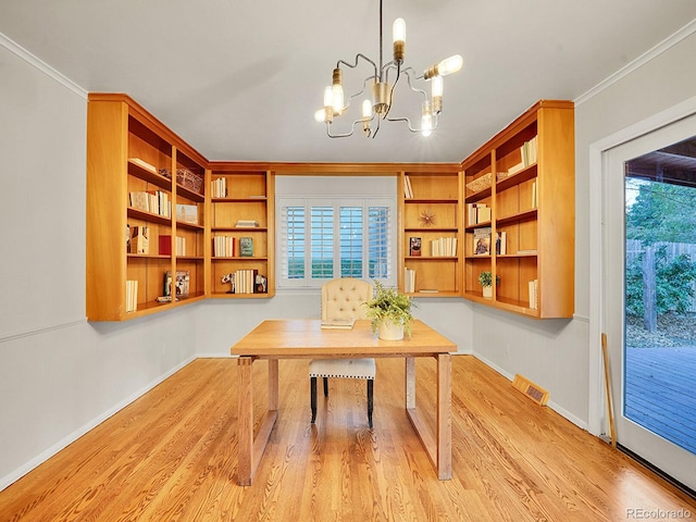 office space with a notable chandelier, light wood-type flooring, and ornamental molding