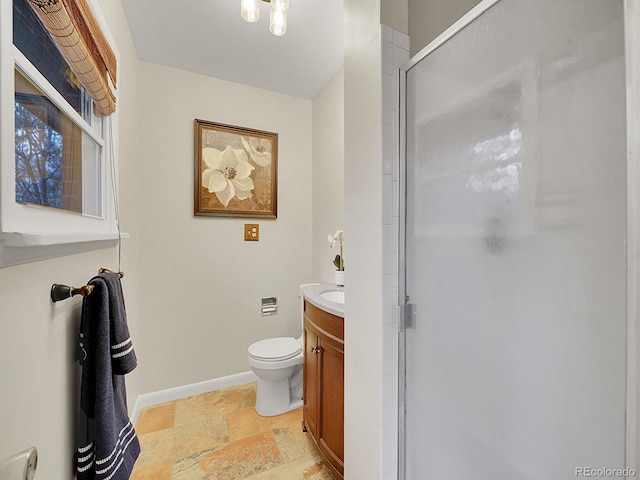 bathroom featuring walk in shower, vanity, and toilet