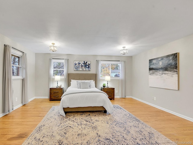 bedroom with light hardwood / wood-style flooring and multiple windows