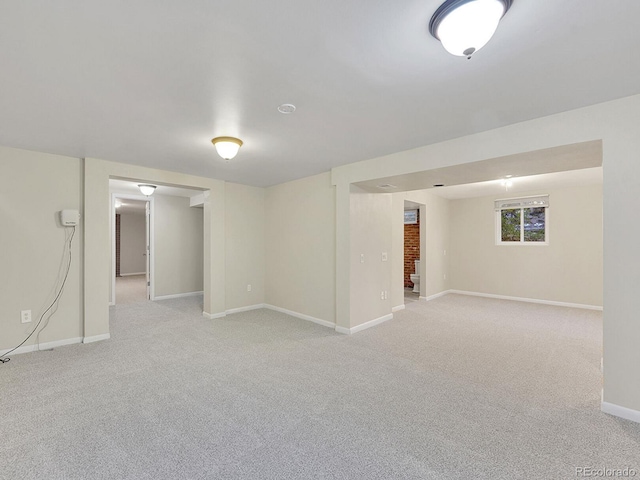 basement featuring light carpet