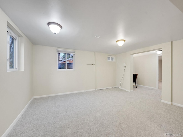 basement featuring light carpet