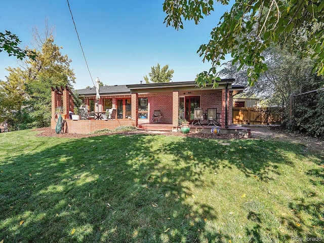 back of house with a lawn and a patio area