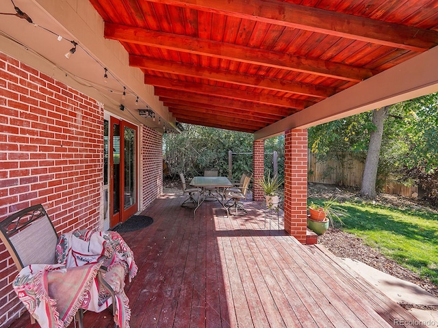 wooden terrace featuring a lawn