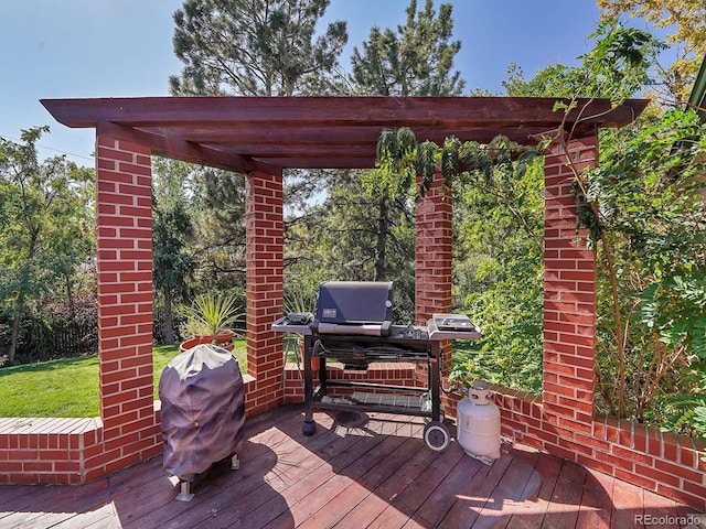 wooden terrace featuring a pergola and a grill