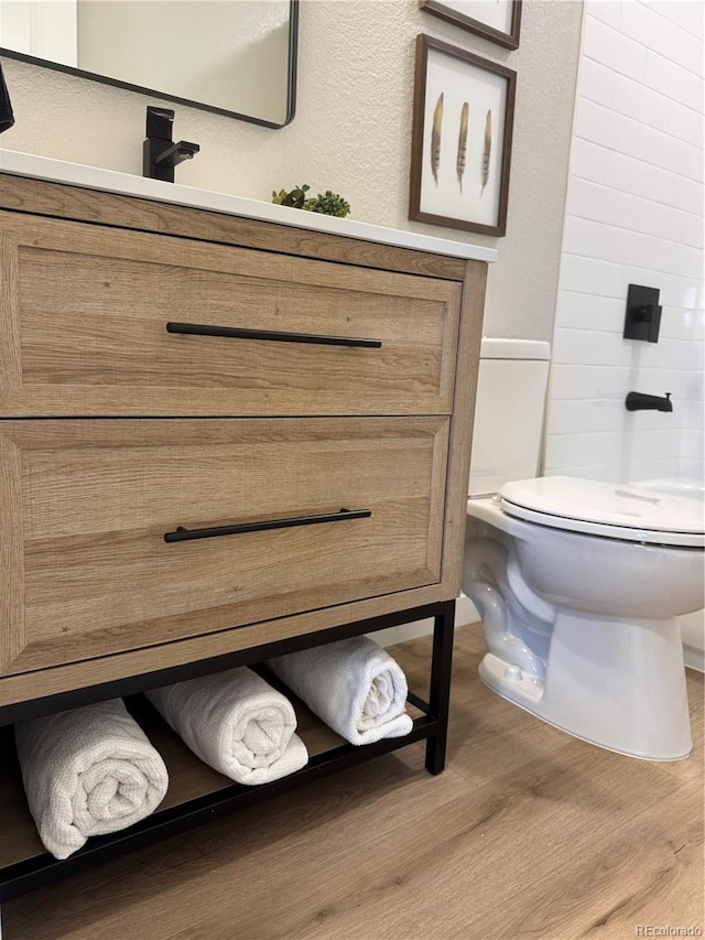 bathroom with wood finished floors and toilet