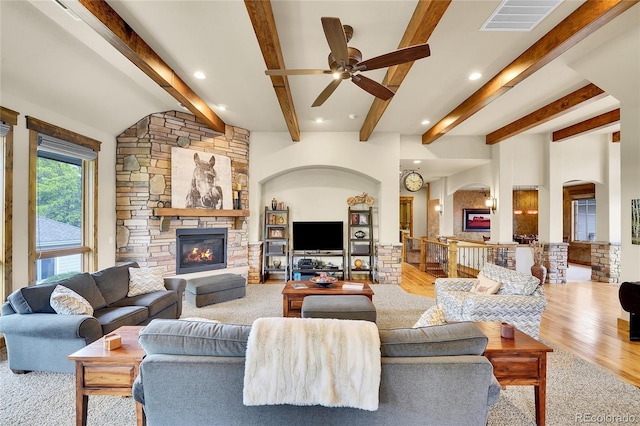 6349 Southridge Greens Blvd, Fort Collins, CO 80525 - living area with a ceiling fan, a stone fireplace, beam ceiling, arched walkways, and recessed lighting