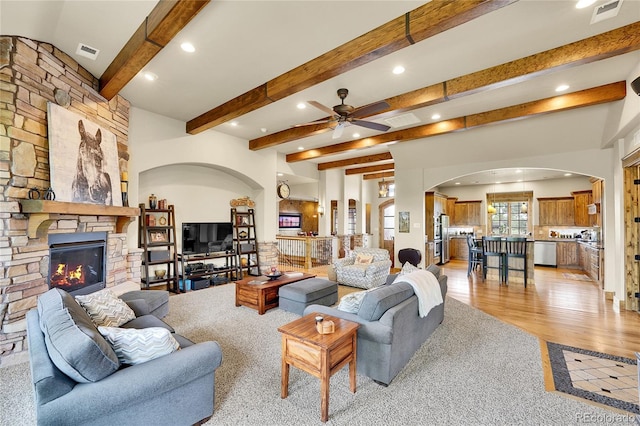 6349 Southridge Greens Blvd, Fort Collins, CO 80525 - living room featuring a ceiling fan, recessed lighting, arched walkways, a fireplace, and beam ceiling