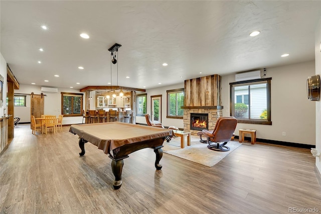 6349 Southridge Greens Blvd, Fort Collins, CO 80525 - recreation room featuring a wall mounted air conditioner, recessed lighting, light wood-type flooring, and plenty of natural light