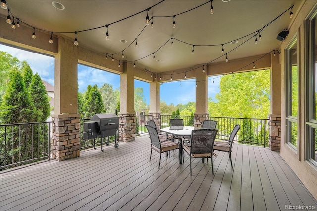 6349 Southridge Greens Blvd, Fort Collins, CO 80525 - wooden deck featuring area for grilling, outdoor dining space, and view of wooded area
