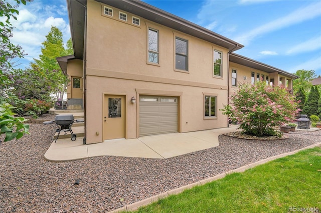6349 Southridge Greens Blvd, Fort Collins, CO 80525 - rear view of house with stucco siding and a patio