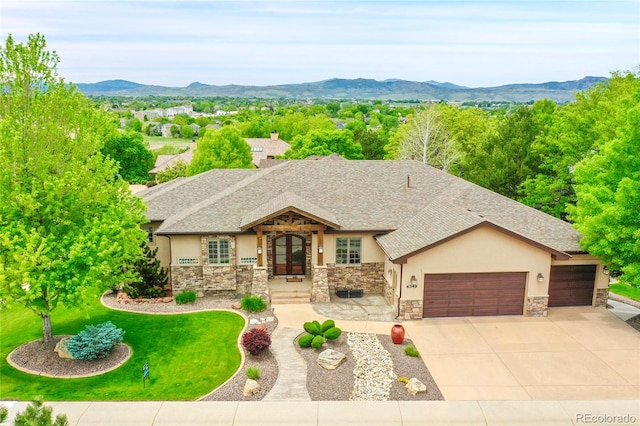 6349 Southridge Greens Blvd, Fort Collins, CO 80525 - view of front of property featuring stucco siding, an attached garage, stone siding, concrete driveway, and a mountain view
