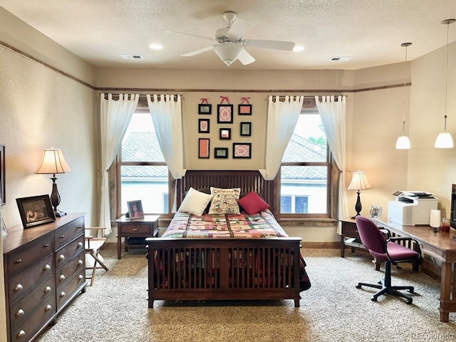 6349 Southridge Greens Blvd, Fort Collins, CO 80525 - carpeted bedroom featuring multiple windows, an office area, a textured ceiling, and a ceiling fan