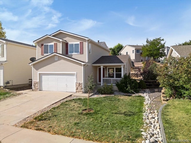 view of front property featuring a garage, a front yard, and covered porch