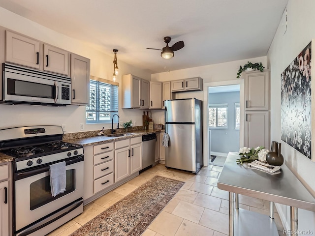 kitchen featuring stainless steel appliances, ceiling fan, sink, gray cabinets, and light tile patterned flooring