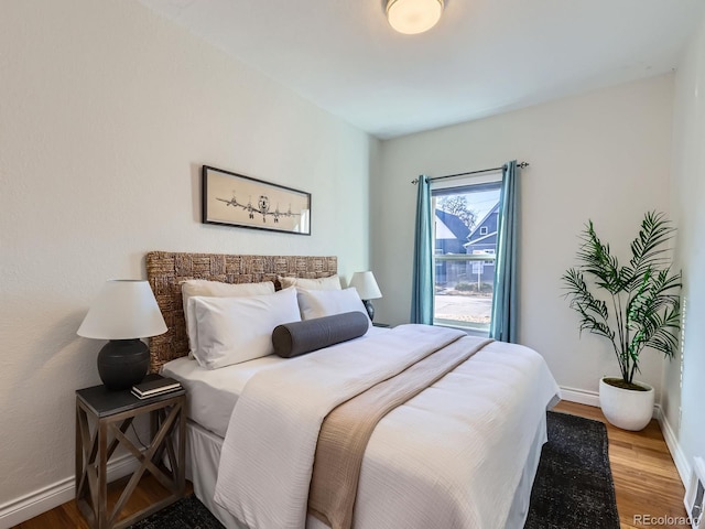 bedroom with hardwood / wood-style flooring