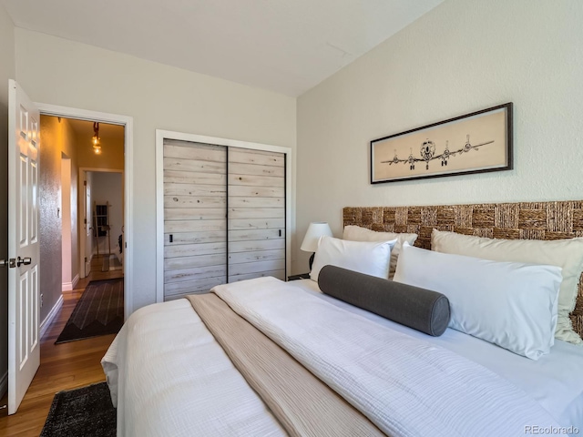 bedroom with hardwood / wood-style floors and a closet