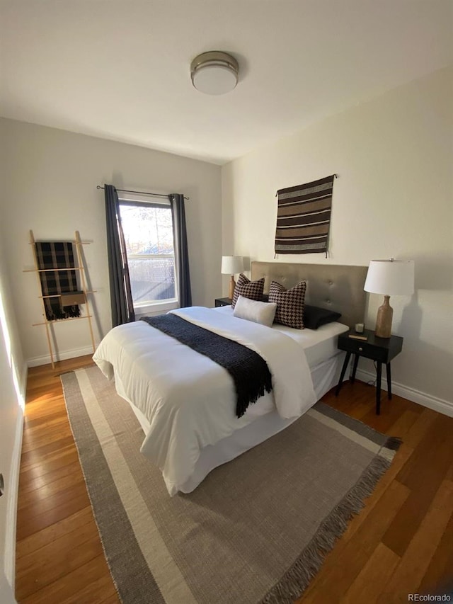 bedroom with hardwood / wood-style flooring