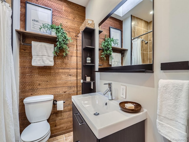 bathroom featuring tile patterned floors, vanity, a shower with shower curtain, and toilet