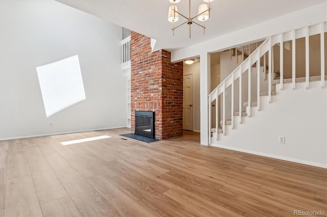 2881 W Long Dr Unit F, Littleton, CO 80120 - unfurnished living room with wood finished floors, a chandelier, stairway, and a skylight