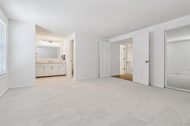 2881 W Long Dr Unit F, Littleton, CO 80120 - unfurnished bedroom featuring light carpet, multiple windows, and connected bathroom