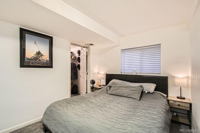 bedroom with carpet floors, baseboards, a spacious closet, visible vents, and a closet