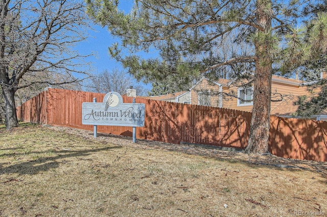 community / neighborhood sign with fence