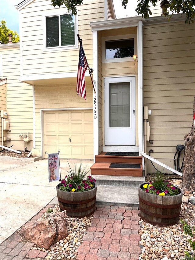 12935 W 64th Dr Unit D, Arvada, CO 80004 - entrance to property featuring concrete driveway and an attached garage