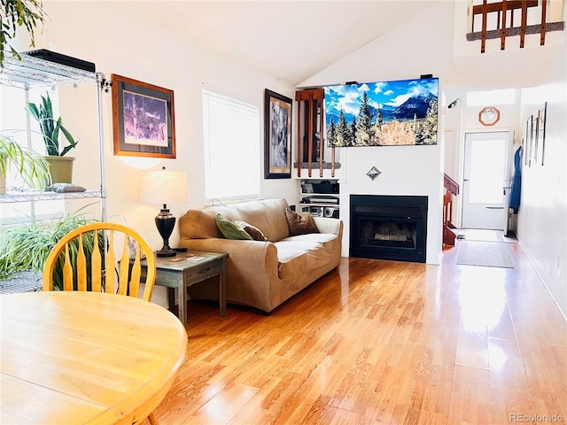12935 W 64th Dr Unit D, Arvada, CO 80004 - living area with light wood-style flooring, a fireplace, and high vaulted ceiling