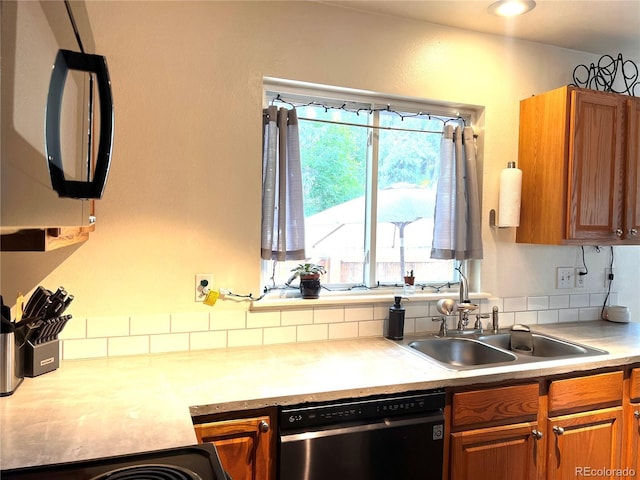 12935 W 64th Dr Unit D, Arvada, CO 80004 - kitchen featuring dishwashing machine, brown cabinetry, light countertops, and stove