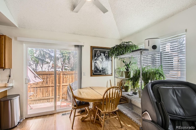 12935 W 64th Dr Unit D, Arvada, CO 80004 - dining area featuring a textured ceiling, light wood-type flooring, lofted ceiling, and a ceiling fan