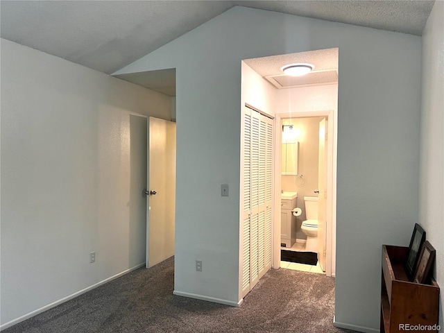 12935 W 64th Dr Unit D, Arvada, CO 80004 - bedroom featuring carpet, vaulted ceiling, and connected bathroom