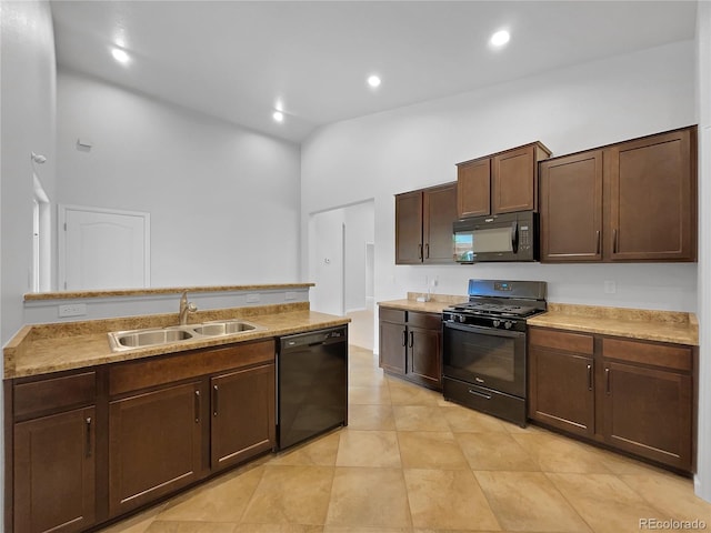 kitchen with high vaulted ceiling, sink, light tile patterned floors, dark brown cabinetry, and black appliances