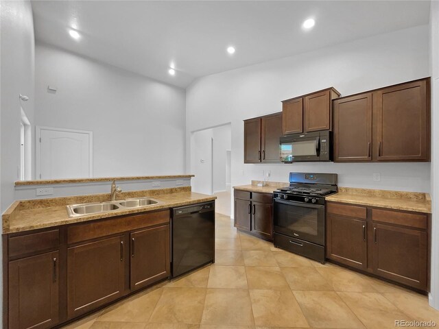 kitchen with high vaulted ceiling, sink, light tile patterned floors, dark brown cabinetry, and black appliances