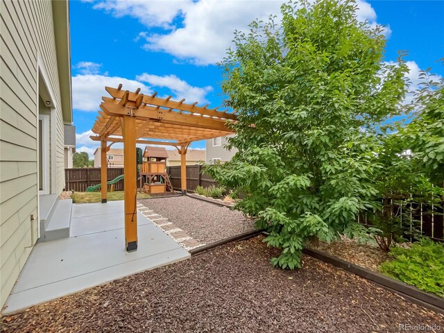 view of patio / terrace with a pergola and a playground