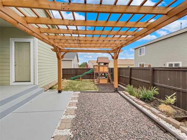 view of yard featuring a pergola, a patio area, and a playground