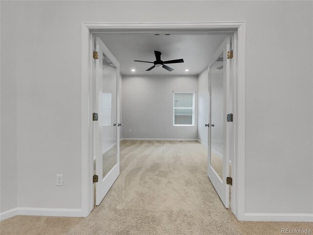 corridor with light colored carpet and french doors