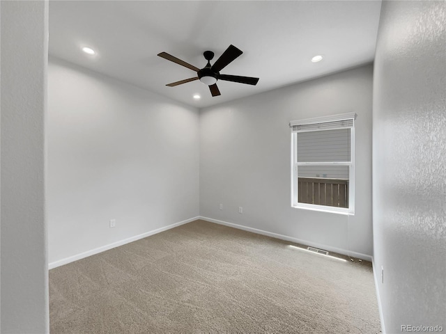 empty room with ceiling fan and carpet floors