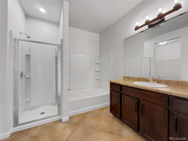 bathroom featuring shower with separate bathtub, tile patterned floors, and vanity