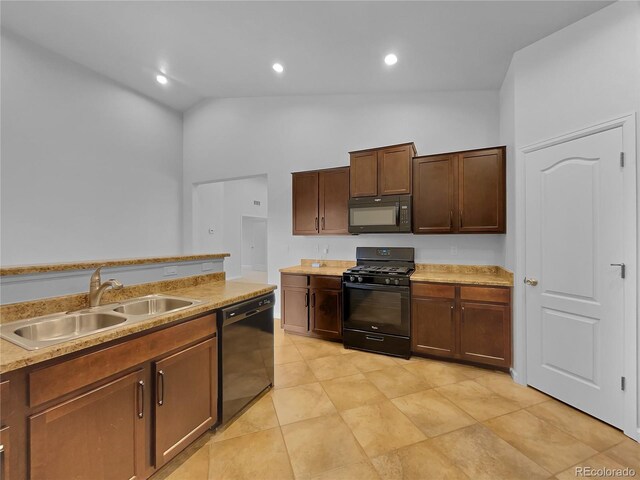 kitchen featuring high vaulted ceiling, sink, and black appliances